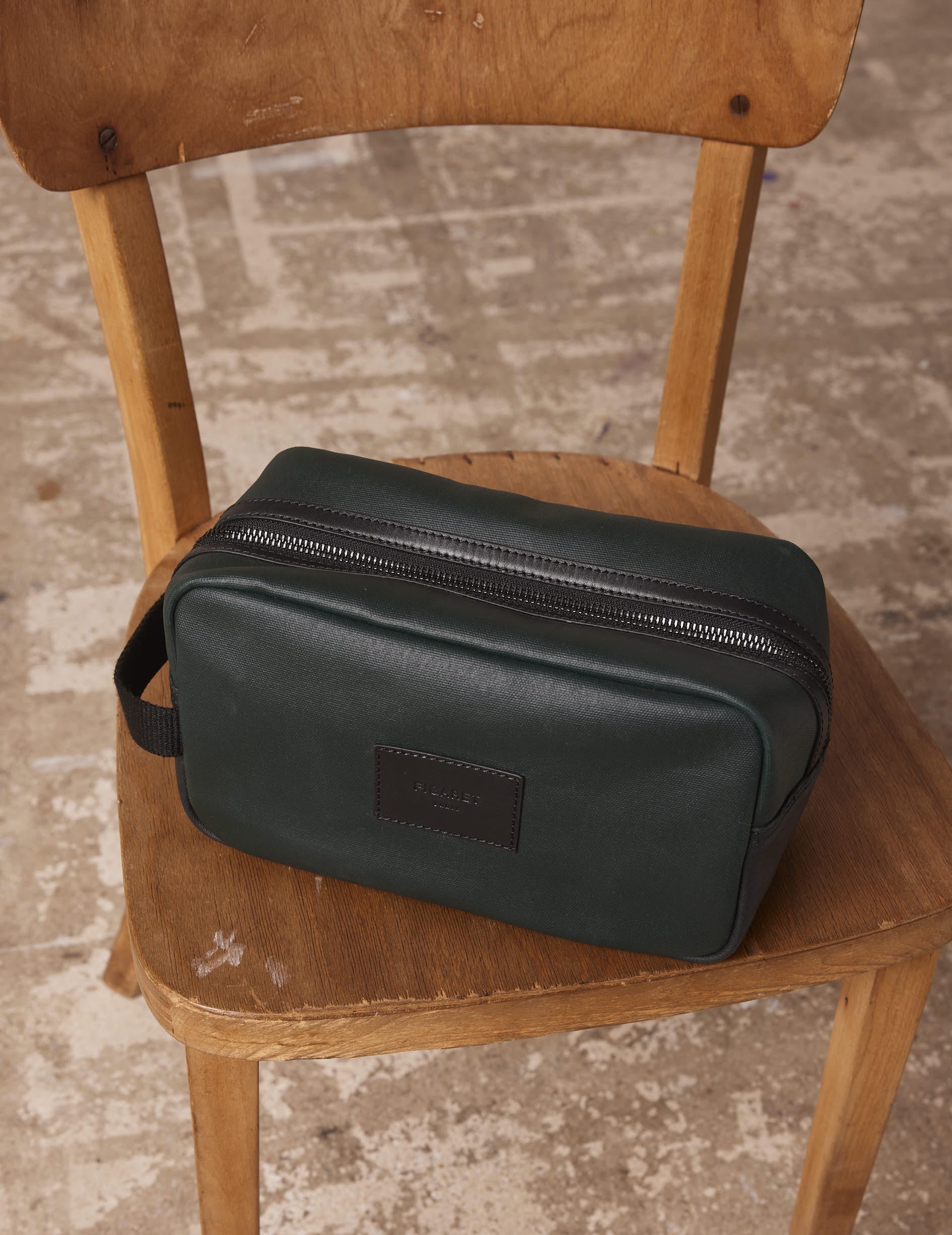 Toiletry bag in coated cotton canvas and green leather